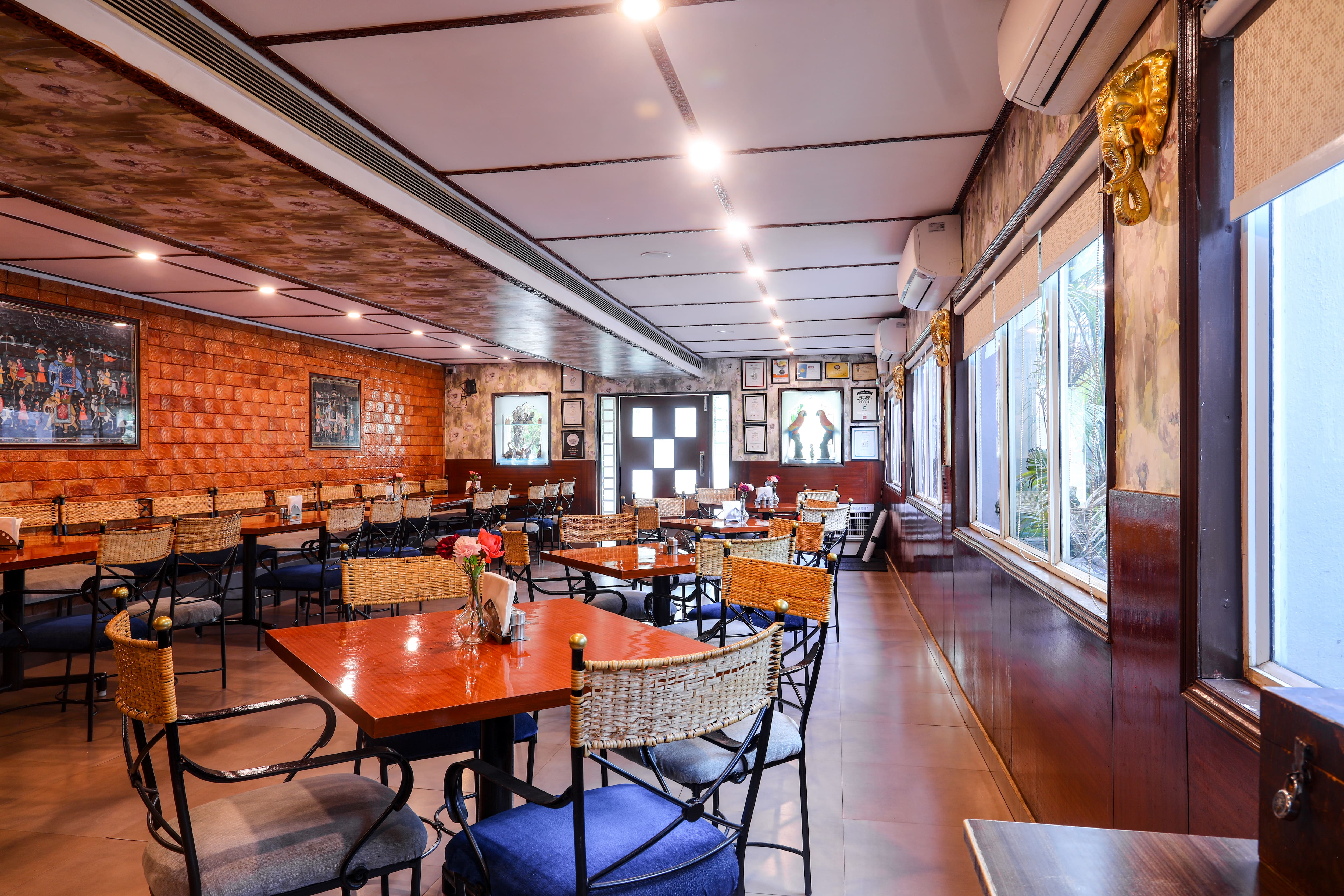 Cane chairs and windows in the dining hall at The Spicy Venue